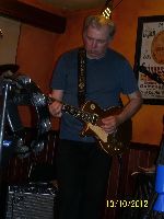 Steve with a huge tambourine on his guitar